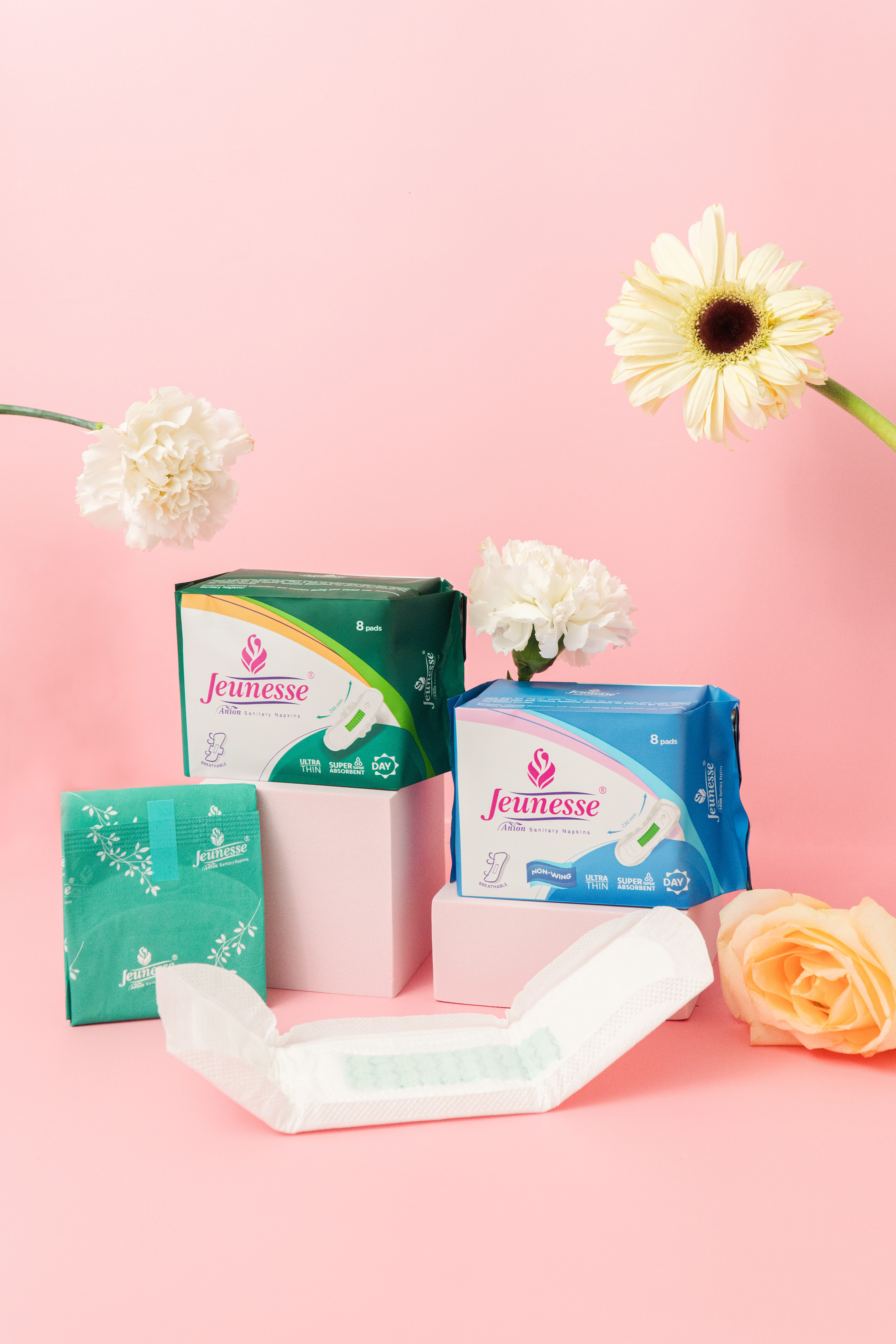 Jeunesse Anion pads and panty liners styled with fresh flowers